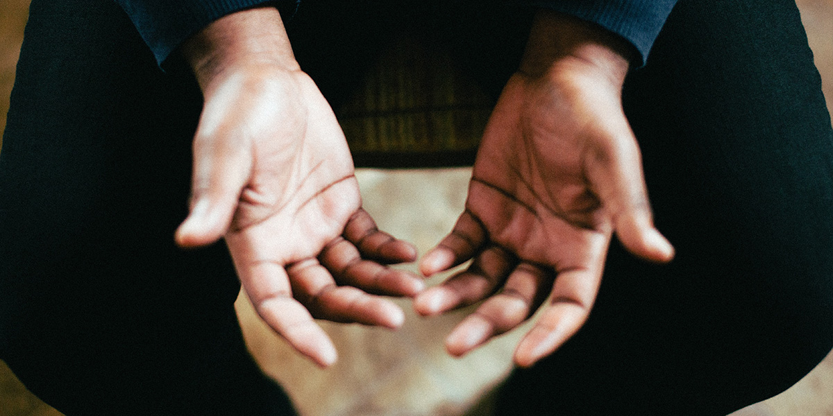 person showing both palms while sitting on chair